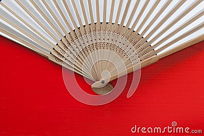 Japanese hand fan made on the red table Stock Photo