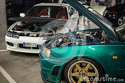 Japanese motorsports, the white Nissan Silvia S15 and the green Nissan GT-R 34 with the hood open Editorial Stock Photo