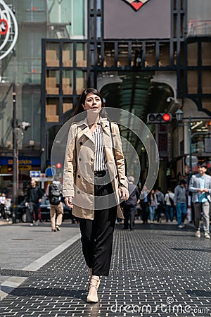 Japanese office lady walking on the street Editorial Stock Photo