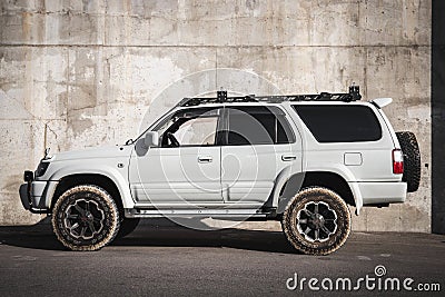 Japanese offroad used white car Toyota Hilux Surf, left side view Editorial Stock Photo