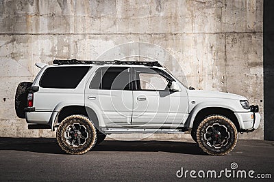 Japanese offroad used white car Toyota Hilux Surf, right side view Editorial Stock Photo