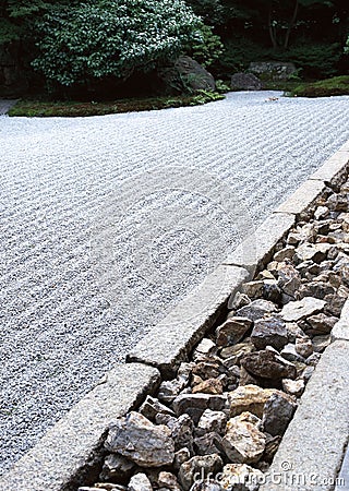 Japanese outdoor garden pathway with green bushes and stone flooring background Stock Photo