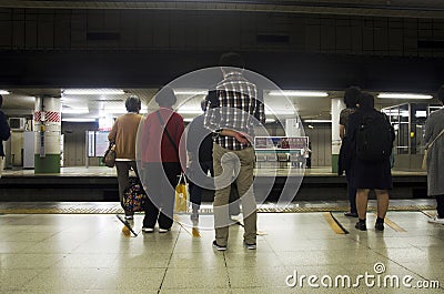 Japanese people and foreigner traveller waiting subway train go Editorial Stock Photo