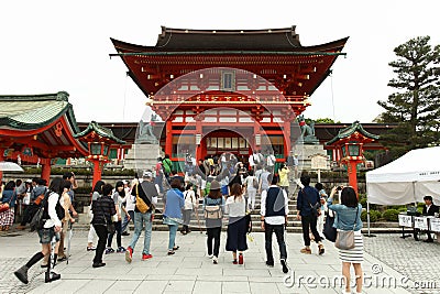 Japanese people and tourists enter Fushimi Inari Shrine Editorial Stock Photo