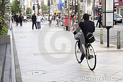 Japanese people walking crosswalk traffic road and biking bicycle on pathway Editorial Stock Photo