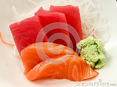 Japanese raw fish on white plate. Also known as Sashimi. Stock Photo