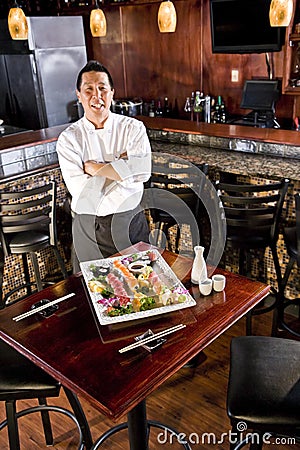 Japanese restaurant chef presenting sushi platter Stock Photo