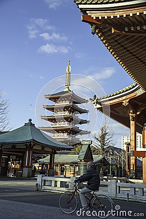 Japanese riding bicycle in the temple Tokyo Editorial Stock Photo