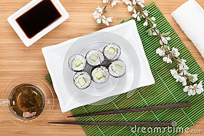 Japanese roll with cucumber and fresh sakura branch Stock Photo