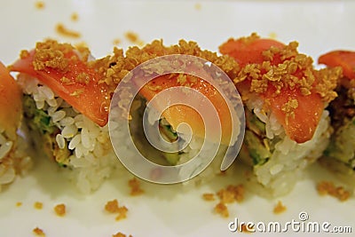 Japanese roll uramaki style with rice outside and seaweed nori inside sharp focus on the raw salmon Stock Photo