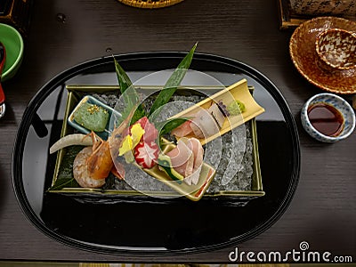 Japanese ryokan kaiseki dinner decorative sashimi set including Pacific blue fin tuna, shrimp, greater amberjack, halfbeak Stock Photo