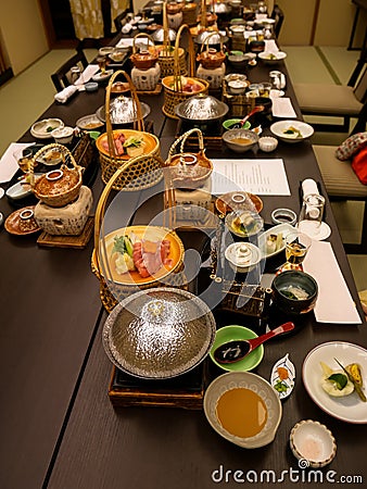 Japanese ryokan kaiseki dinner sets serve in family private room including appetizer such as cherry blossom tofu, pork shabu Stock Photo