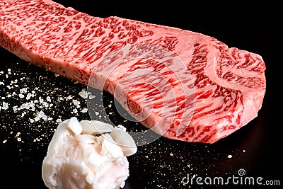 Beef isolated on the black with salt pepper and beef tallow Stock Photo