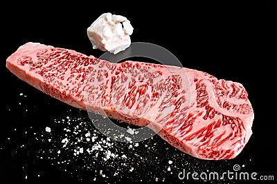 Beef isolated on the black with salt pepper and beef tallow Stock Photo