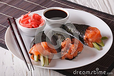 Japanese Salmon temaki sushi, ginger and sauce closeup. horizontal Stock Photo