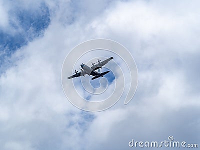 Japanese self defense force C-130 airplane flying above Naval Air Facility Atsugi before landing Editorial Stock Photo