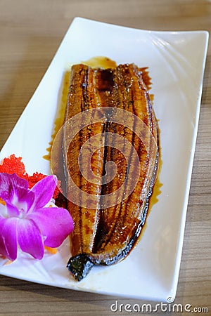 Japanese shoulder fish roasted whole. Topped with sweet and sour Stock Photo