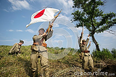 Japanese soldiers-reenactors reproduce the attack on the Soviet army during the Second World War Editorial Stock Photo