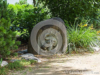 Japanese stone sculpture dragon bas-relief. Landscaping Stock Photo