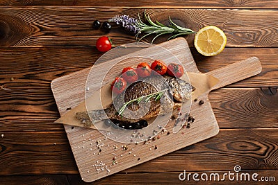 Japanese style dorado with tomatoes and black olives Stock Photo