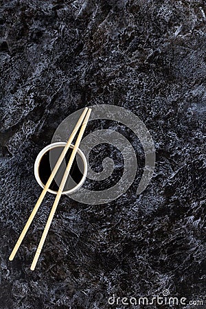 Japanese sushi chopsticks and soy sauce on black background. Top view with copyspace Stock Photo