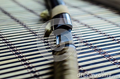 Japanese sword katana on bamboo mat. Selective focus Stock Photo