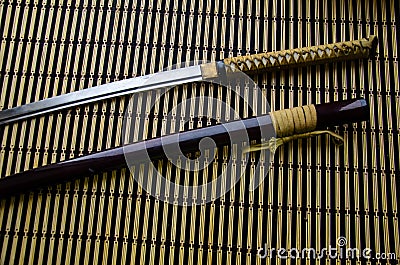 Japanese sword katana and sheath on bamboo mat Stock Photo