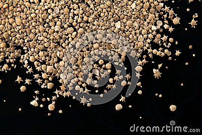 Japanese Taketomi beach star sand closeup on black Stock Photo