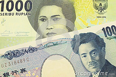 A Japanese thousand yen note paired with a green one thousand bank note from Indonesia. Stock Photo