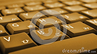 Japanese typing. Laptop keyboard closeup. Symbols on buttons of hiragana. Bright brown tinted computer wallpaper or background. Stock Photo