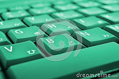 Japanese typing. Light green laptop keyboard close-up. Symbols on the buttons of hiragana. Electronic commerce in Japan. IT Stock Photo