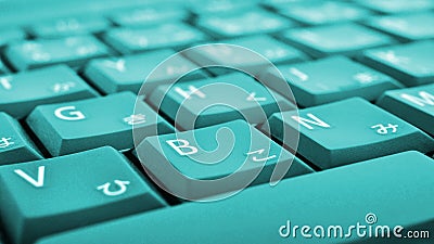 Japanese typing. Turquoise laptop keyboard closeup. Symbols on buttons of hiragana. Light teal tinted computer wallpaper or Stock Photo