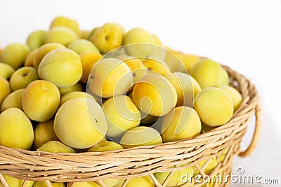 Fresh Japanese UME plum in wicker basket Stock Photo