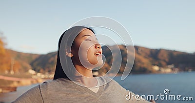 Japanese woman, freedom and peace outdoor, lake or ocean with travel, holiday and mindfulness in nature. Wellness Stock Photo