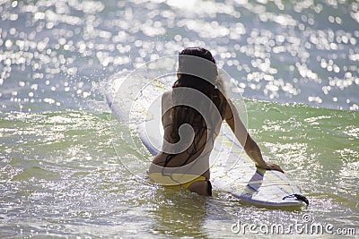 Japanese woman surfing in hawaii Stock Photo
