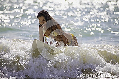 Japanese woman surfing in hawaii Stock Photo