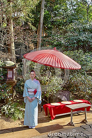 Japanese Woman in Traditional Blue Kimono with Tachidoro and Umbrella Editorial Stock Photo