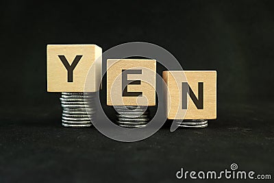 Japanese yen weakening, value depreciation and devaluation concept. Decreasing stack of coins Stock Photo