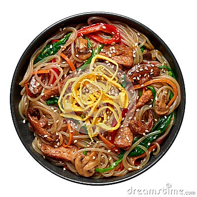 Japchae in black bowl isolated on white. Korean cuisine glass chapchae noodles dish with vegetables and meat Stock Photo