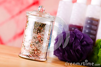 Jar with bath salt askew placed on wooden board Stock Photo