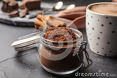 Jar of cocoa powder on grey table Stock Photo