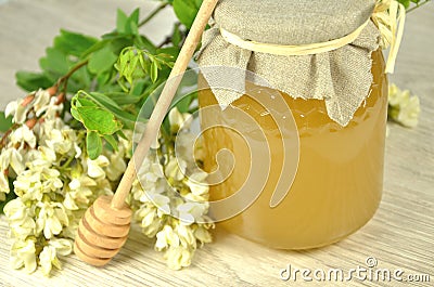 Jar of fresh delicious honey with acacia flowers a Stock Photo