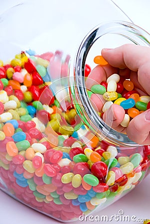 Jar and handful of jelly beans Stock Photo