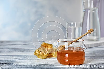 Jar of honey and dipper Stock Photo