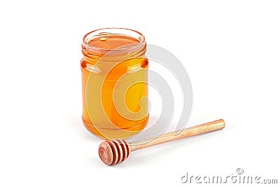 Jar of honey and honey dipper Stock Photo