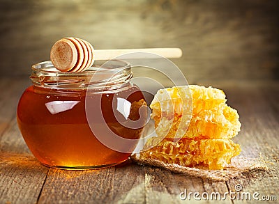 Jar of honey with honeycomb Stock Photo
