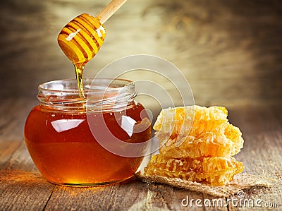 Jar of honey with honeycomb Stock Photo