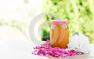 Jar of honey, pink and white petals and peony flowers, isolate Stock Photo