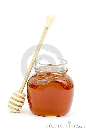 Jar of honey and wooden dripper Stock Photo