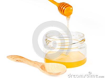 Jar of honey with wooden drizzler Stock Photo